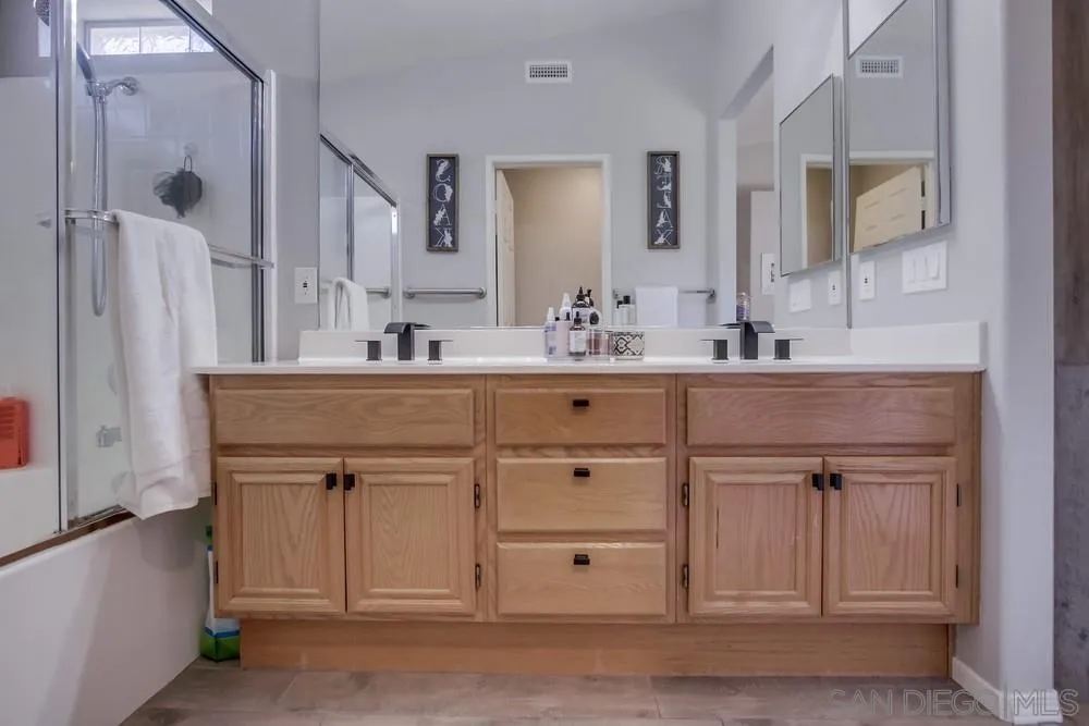 1966 Verbena Terrace Alpine, CA 91901 - Photo 23 of 41 a bathroom with a sink vanity and mirror