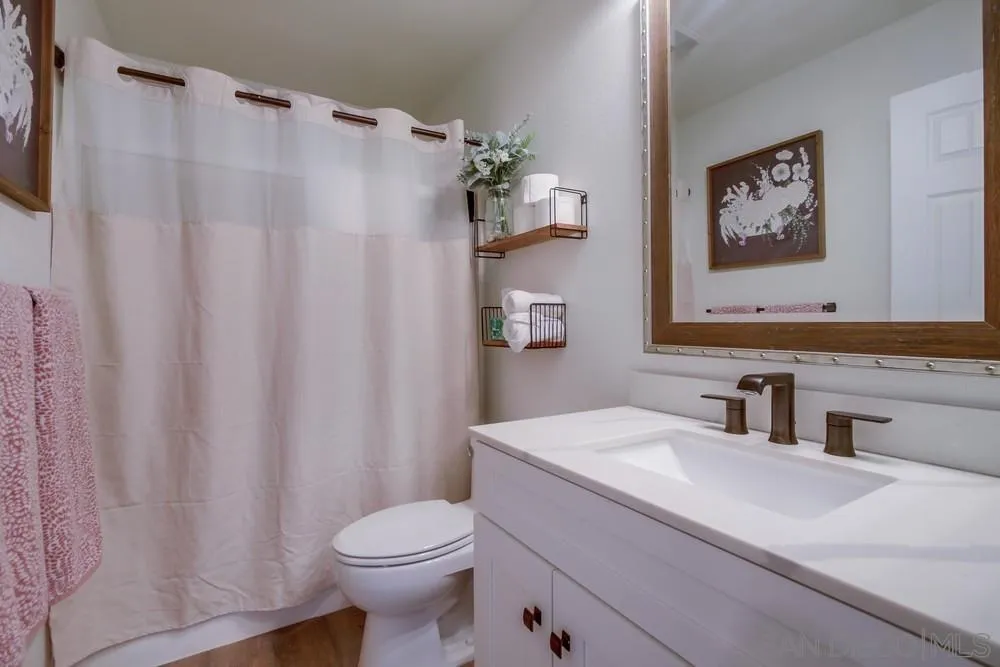 1966 Verbena Terrace Alpine, CA 91901 - Photo 29 of 41 a bathroom with a sink a toilet and a mirror