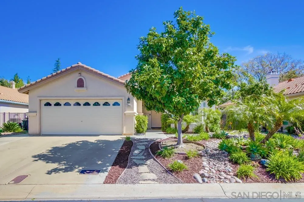 1966 Verbena Terrace Alpine, CA 91901 - Photo 3 of 41 a front view of a house with a yard and garage
