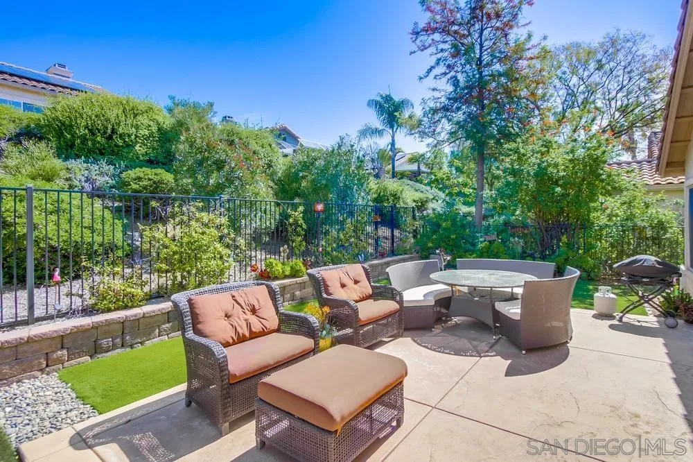 1966 Verbena Terrace Alpine, CA 91901 - Photo 37 of 41 a view of a patio with couches and a table and chairs with wooden fence