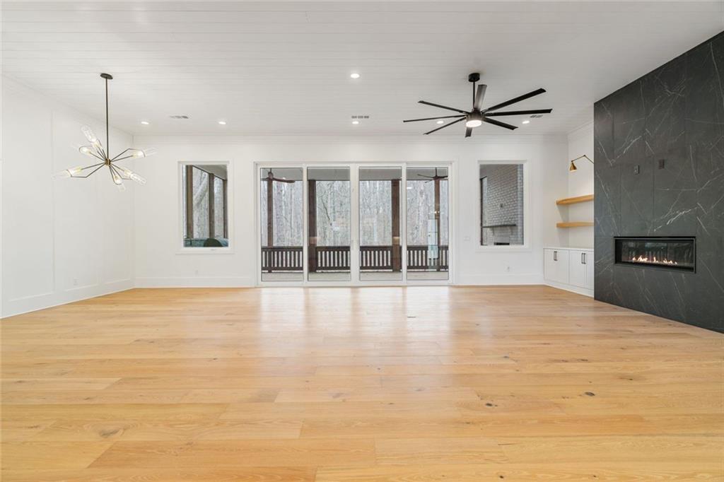 555 Lower Birmingham Road Canton, GA 30115 - Photo 49 of 104 a view of an empty room with chandelier fan and kitchen view