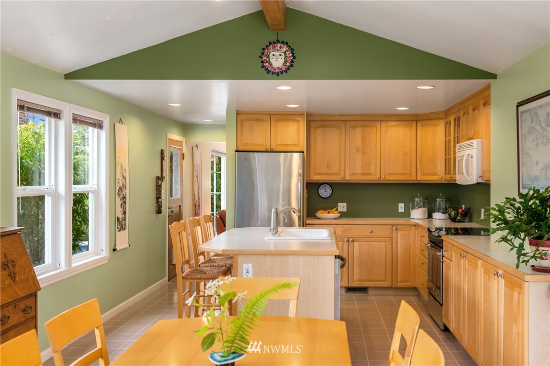 2315 North 57th Street Seattle, WA 98103 - Photo 11 of 35 a kitchen with a sink appliances cabinets and dining table