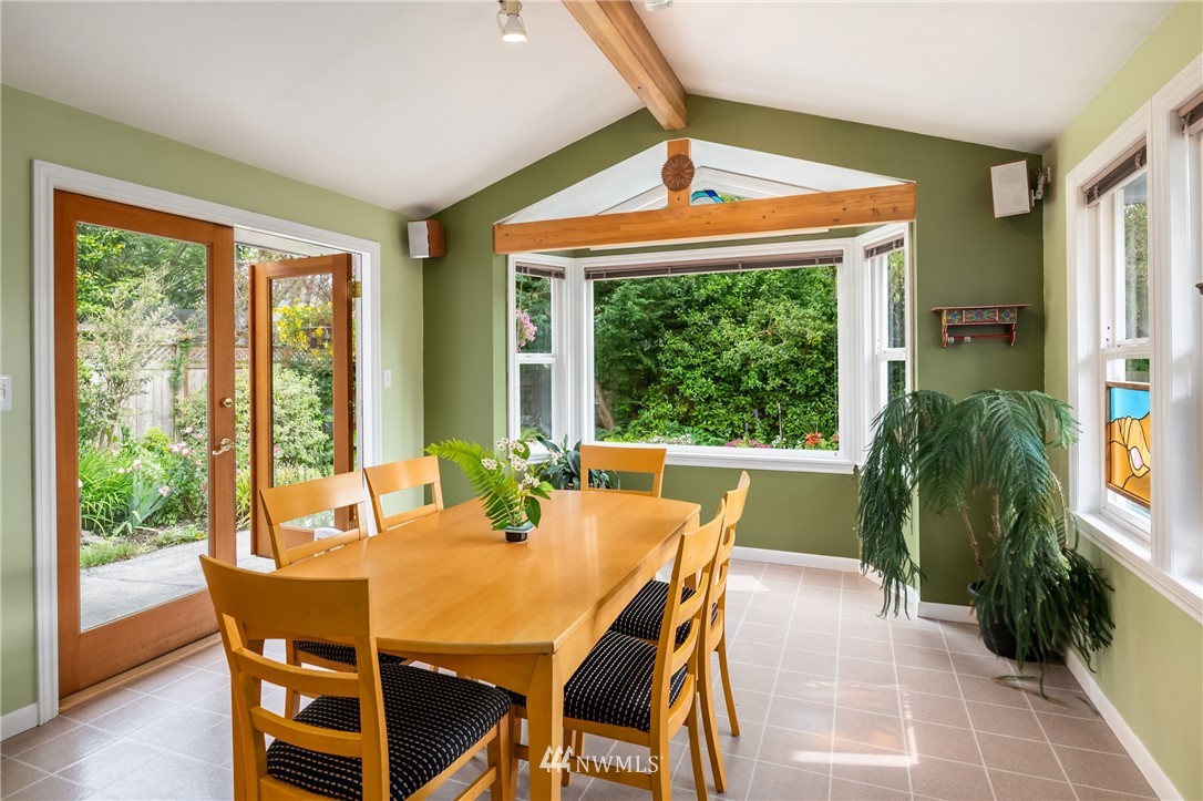 2315 North 57th Street Seattle, WA 98103 - Photo 16 of 35 a dining room with furniture a chandelier and wooden floor