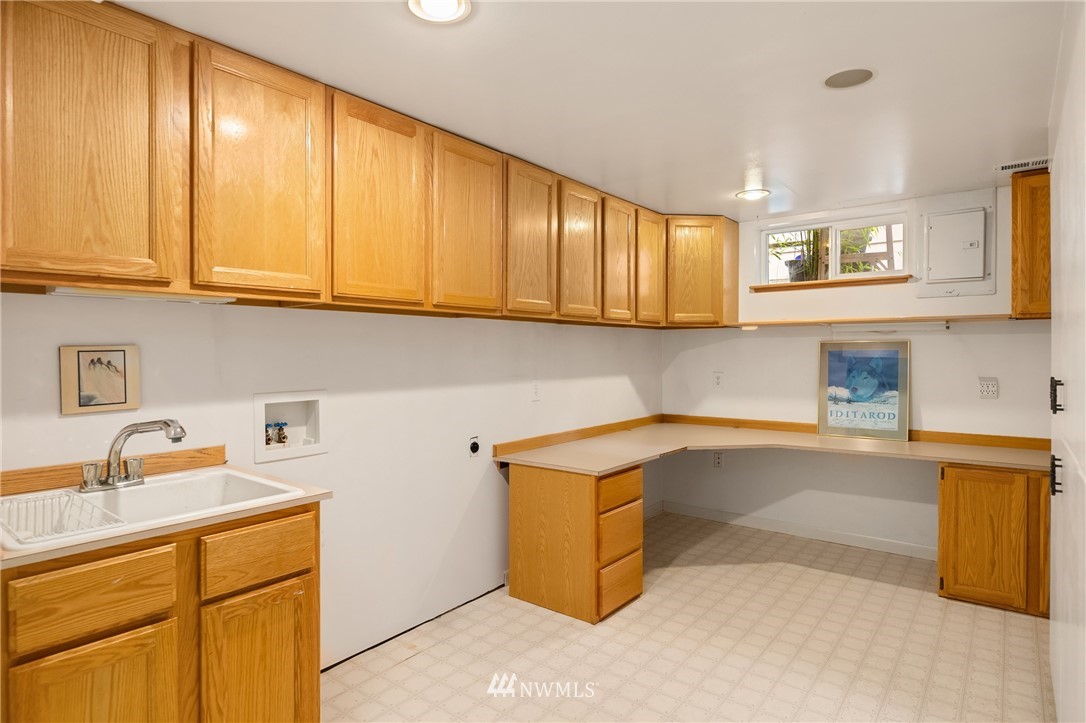 2315 North 57th Street Seattle, WA 98103 - Photo 31 of 35 a kitchen with a sink cabinets and a window