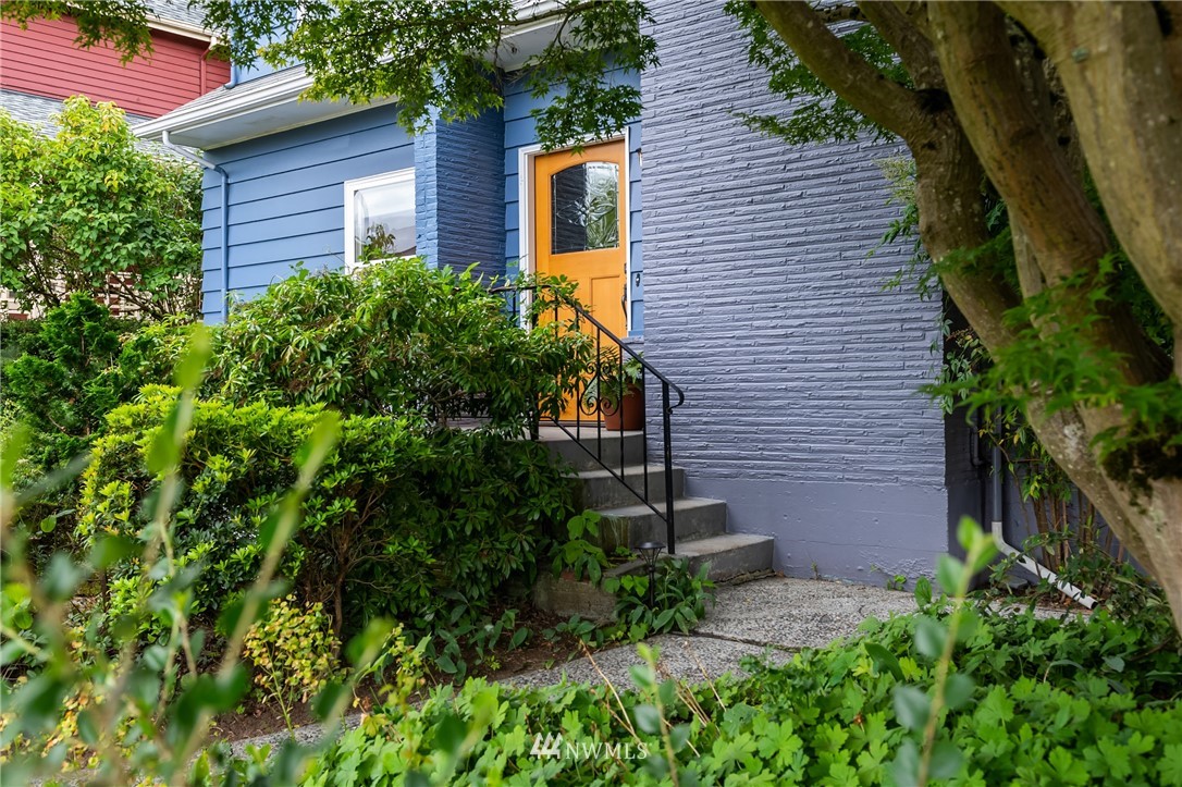 2315 North 57th Street Seattle, WA 98103 - Photo 5 of 35 a view of brick house with a yard and plants