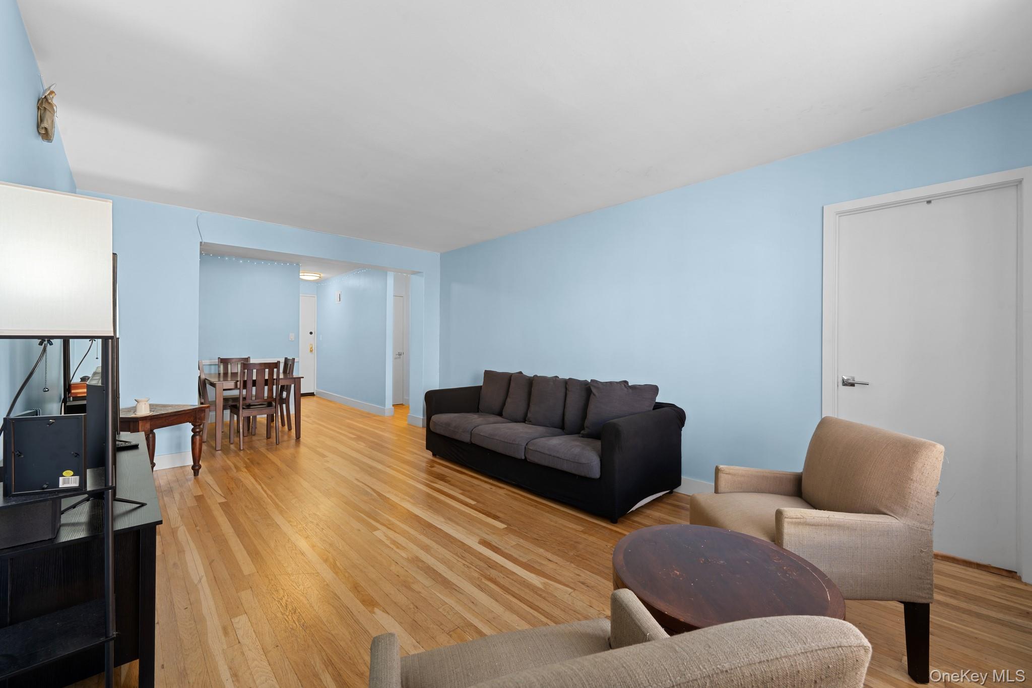 Living room featuring light wood-style flooring and baseboards
