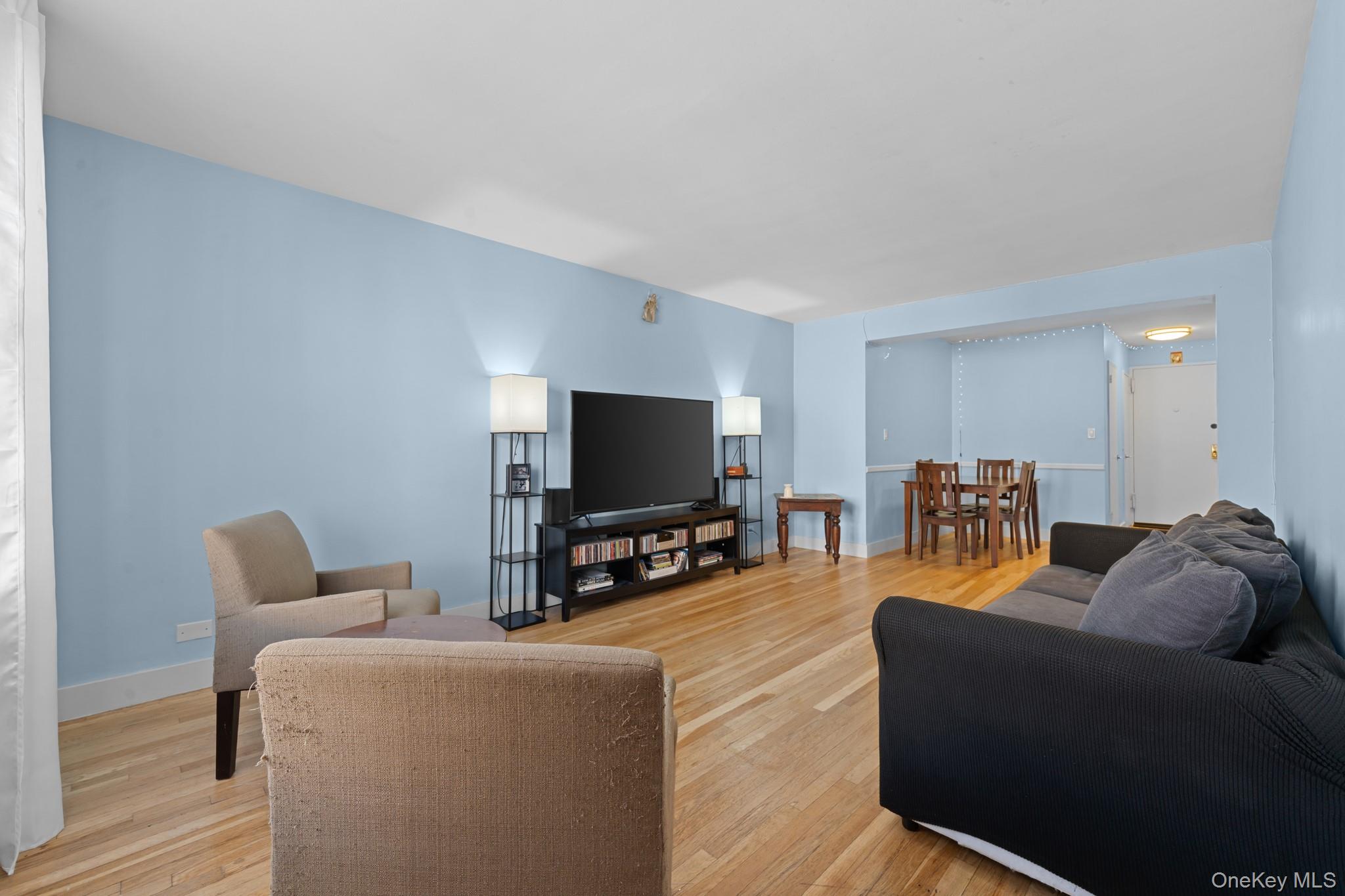 2830 Briggs Avenue, Unit 4F Bronx, NY 10458 - Photo 2 of 16 Living room featuring light wood finished floors and baseboards