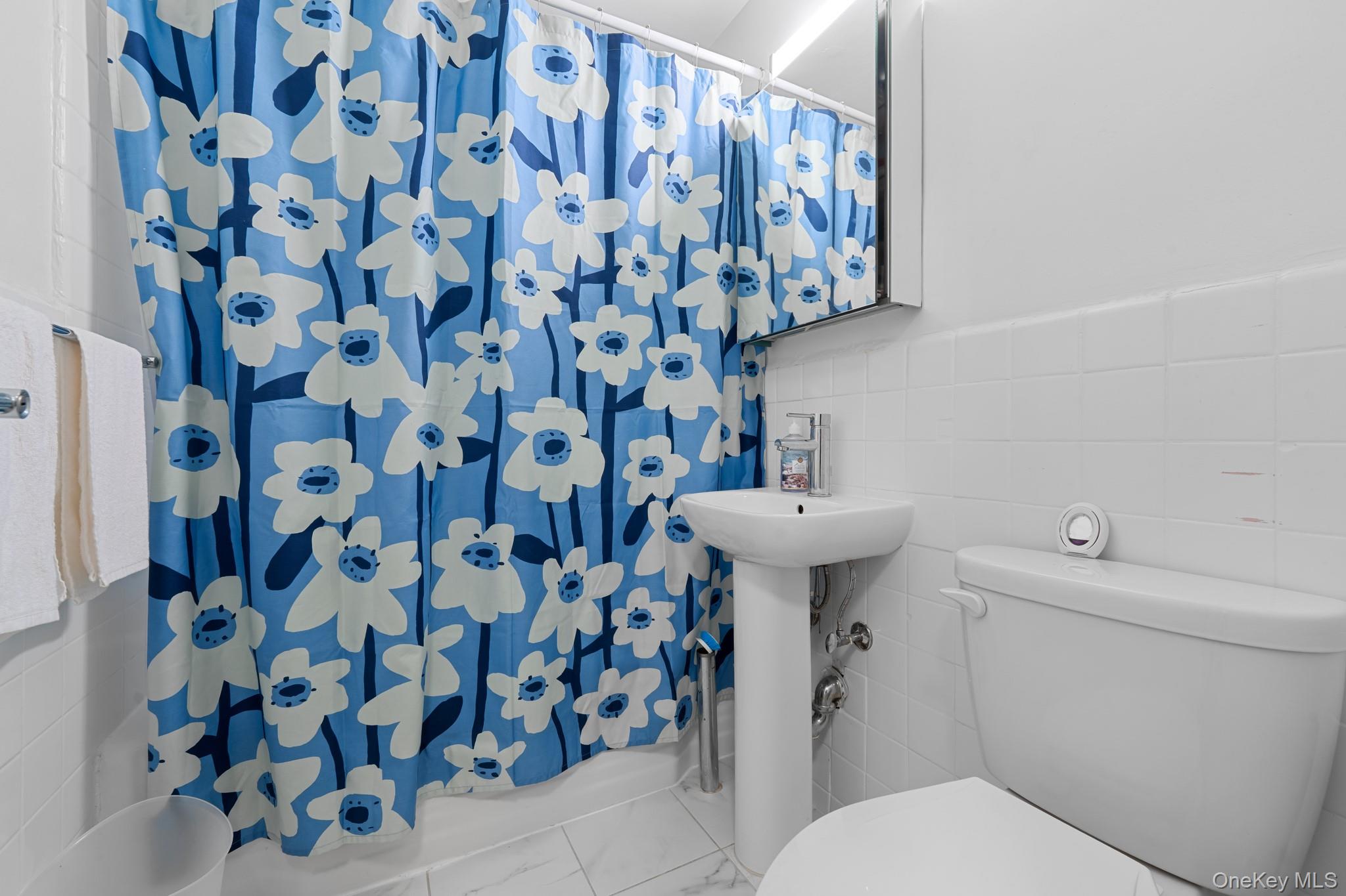 2830 Briggs Avenue, Unit 4F Bronx, NY 10458 - Photo 6 of 16 Bathroom with tile walls and toilet