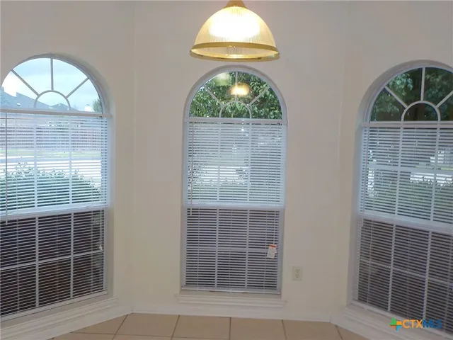 a kitchen with a sink a stove and cabinets