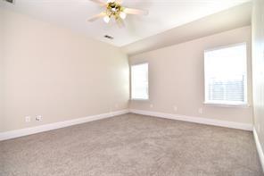 321 South Chestnut Street Forney, TX 75126 - Photo 21 of 27 an empty room with windows and chandelier fan