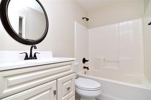 321 South Chestnut Street Forney, TX 75126 - Photo 22 of 27 a bathroom with a toilet a sink and a mirror