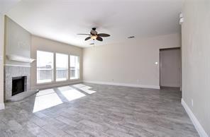 321 South Chestnut Street Forney, TX 75126 - Photo 3 of 27 a view of an empty room with a fireplace and a window