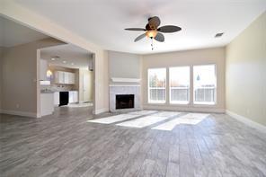 321 South Chestnut Street Forney, TX 75126 - Photo 4 of 27 a view of an empty room with a fireplace and a window