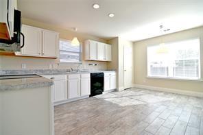 321 South Chestnut Street Forney, TX 75126 - Photo 10 of 27 a kitchen with a stove a sink and a refrigerator