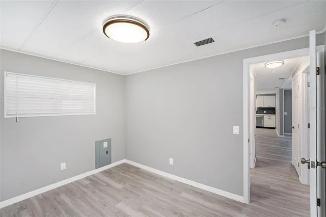 a view of a room with wooden floor