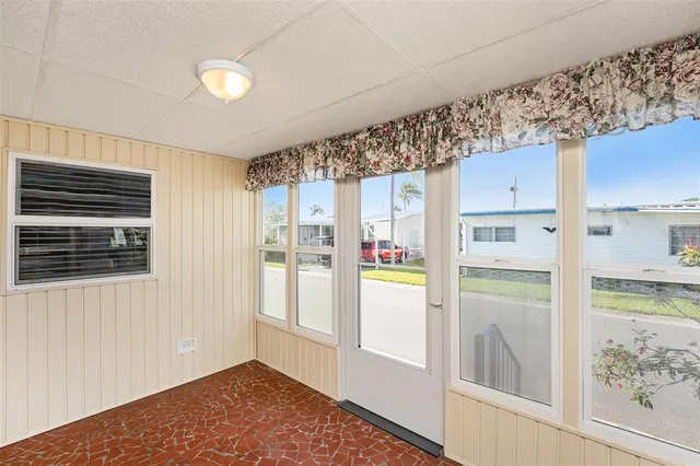 a view of a refrigerator in kitchen and a window