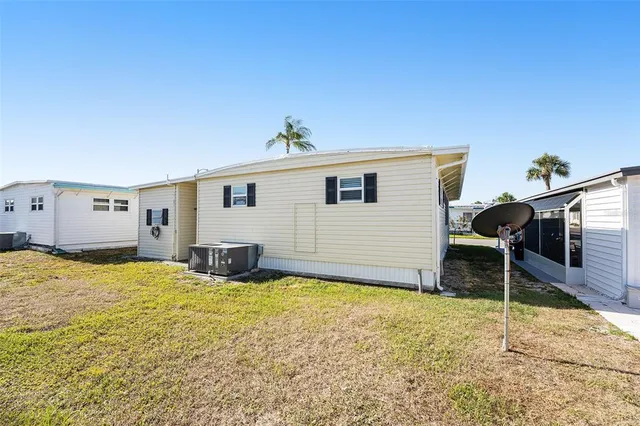 a view of a house with swimming pool and sitting area