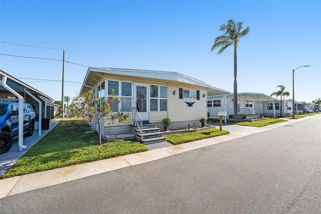 a view of a patio with table and chairs under an umbrella
