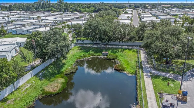 an aerial view of a house with a garden and lake view