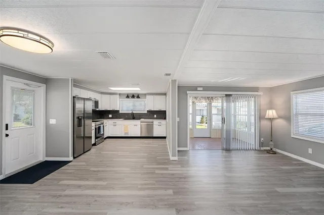 a view of a kitchen with a sink cabinets and wooden floor