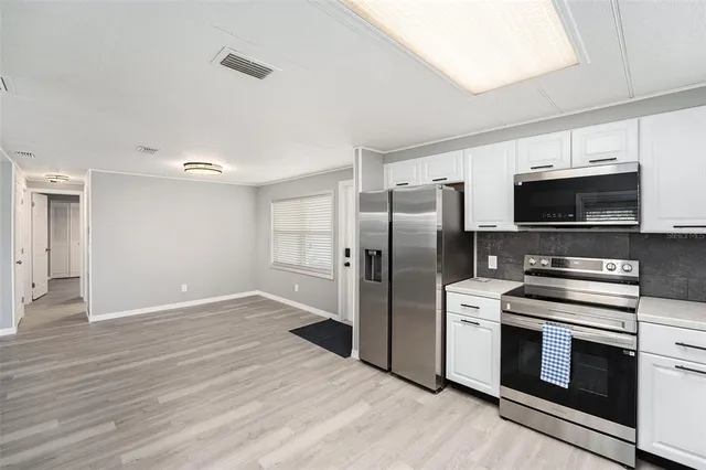 a kitchen with a refrigerator stove and microwave