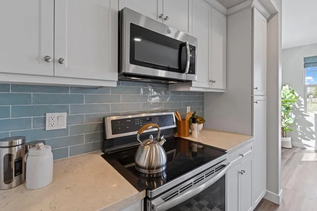 a kitchen with a sink and a stove top oven