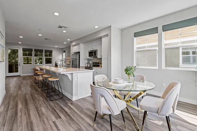 a view of a dining room with furniture window and wooden floor