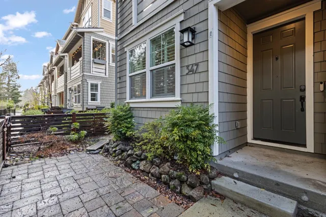 a pathway of a house with a yard