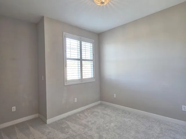 a front view of a residential apartment building with a yard