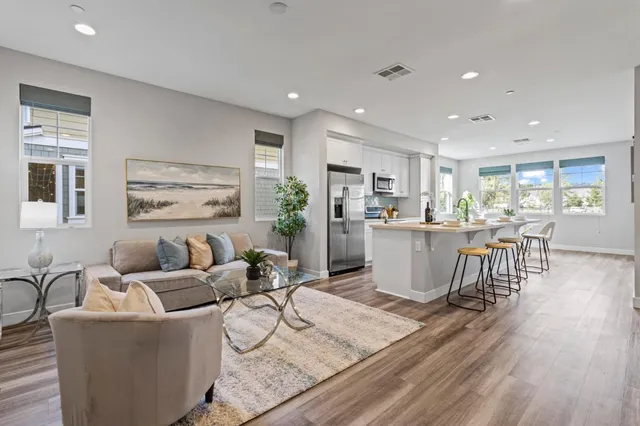a living room with furniture and kitchen view