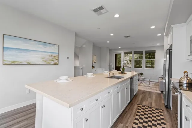 a kitchen with a sink stove and cabinets