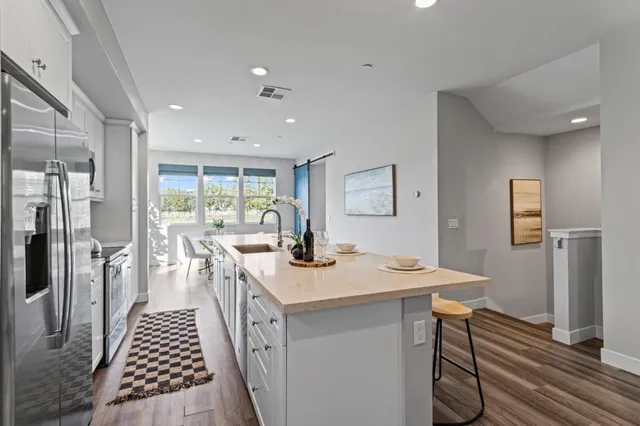a kitchen with a sink and refrigerator