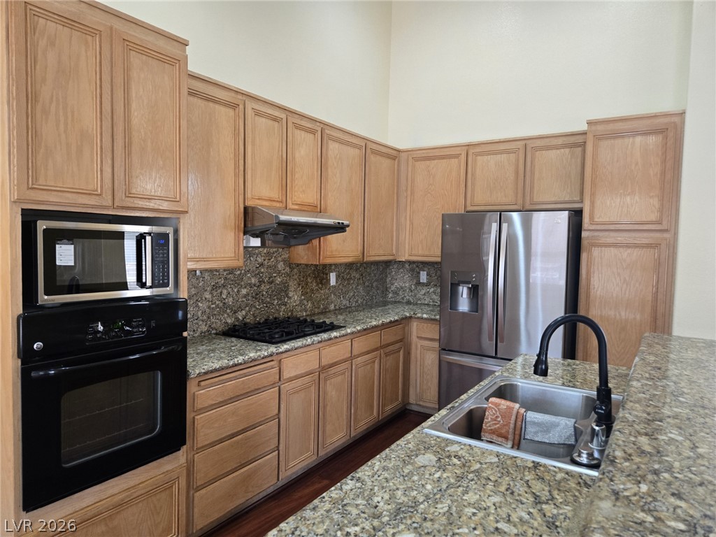 8417 San Ramon Drive Las Vegas, NV 89147 - Photo 14 of 33 Culinary adventures await in this kitchen featuring stainless steel appliances and ample counter space.