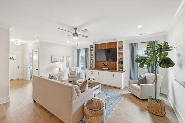 a living room with furniture and a chandelier
