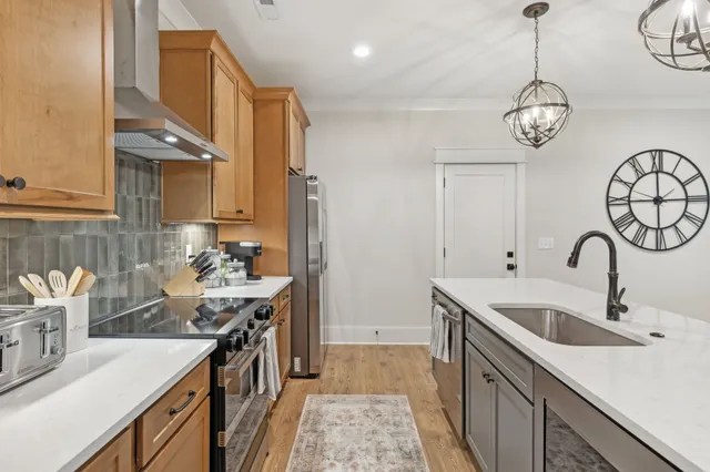 a view of a hallway with wooden floor and entryway