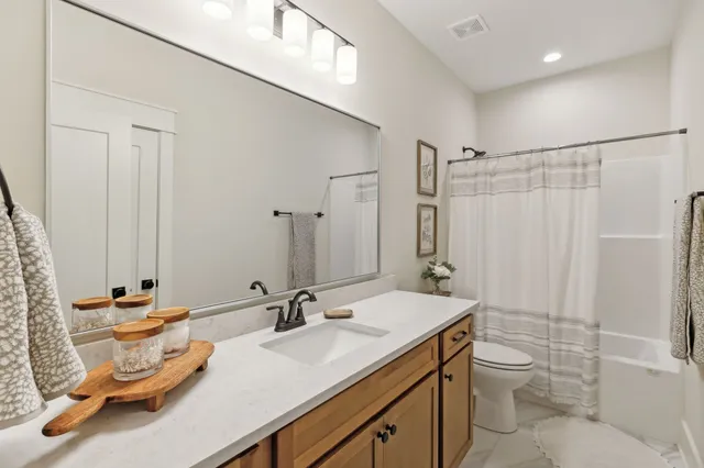 a bedroom with a bed and a ceiling fan