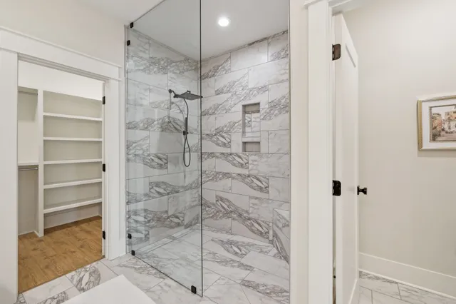 a bathroom with a double vanity sink mirror and shower