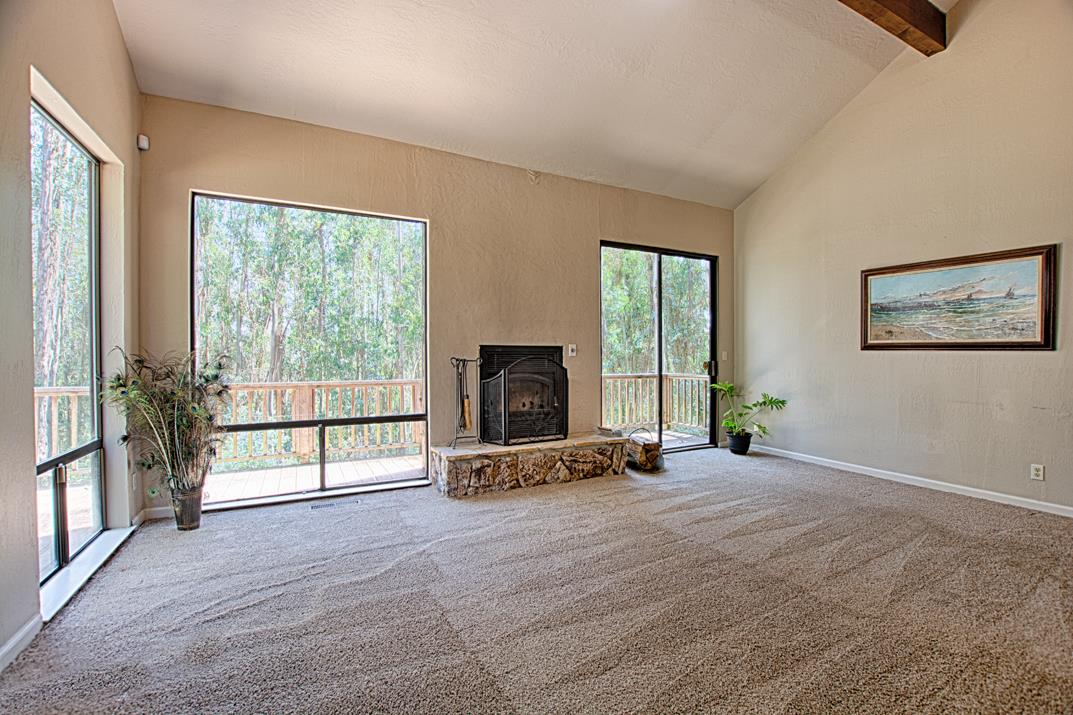 217 Gillette Road Watsonville, CA 95076 - Photo 10 of 16 a view of an empty room with windows and a fireplace