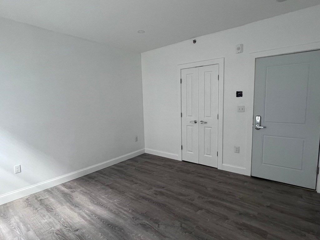 69 North Common Street, Unit 5 Lynn, MA 01902 - Photo 14 of 22 a view of an empty room with wooden floor