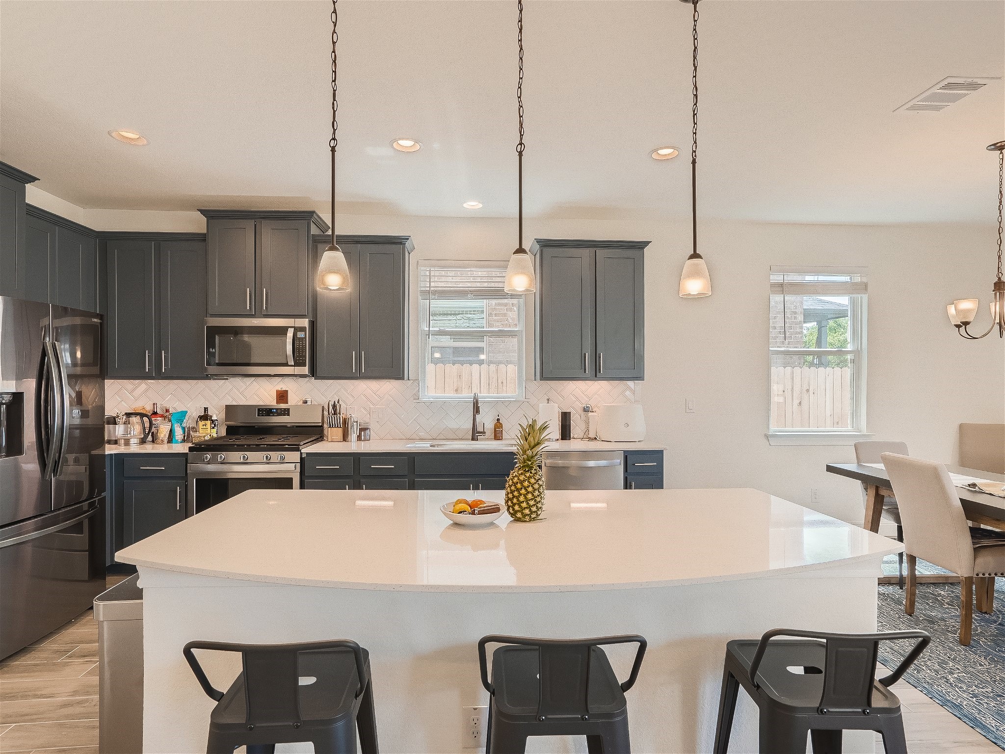 412 Arrowhead Vine Street Leander, TX 78641 - Photo 9 of 30 Huge quartz island with plenty of places to sit for breakfast, set up a buffett or to gather for a drink