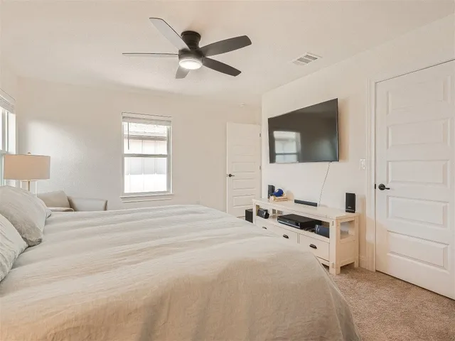 a bedroom with a bed couch and window