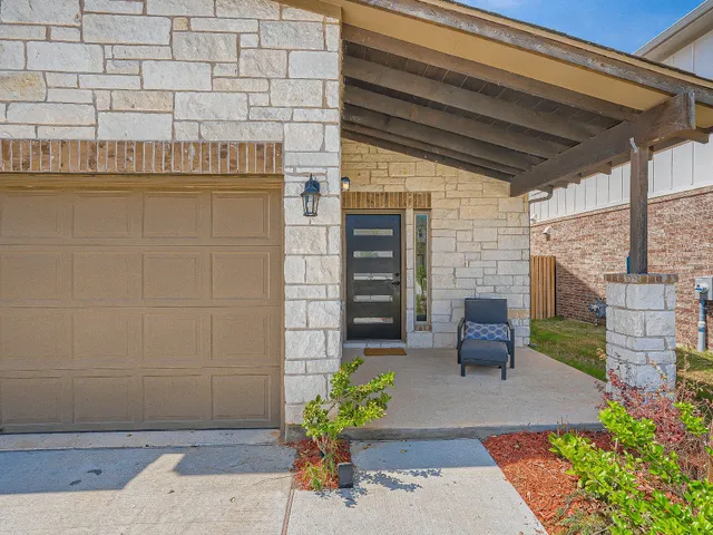a view of a patio with table and chairs and potted plants