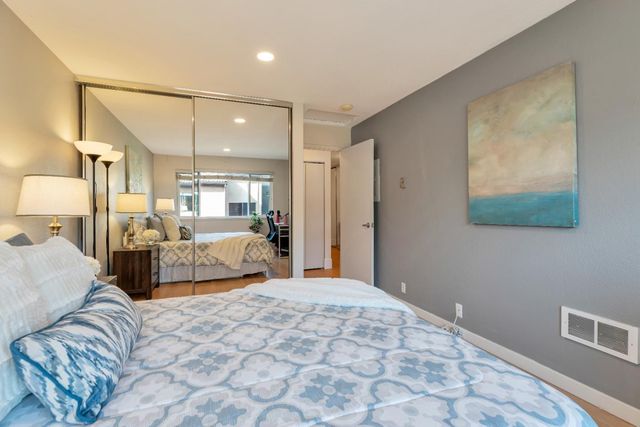 a bedroom with a large bed and a chandelier