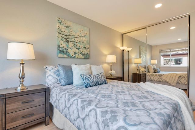 a bedroom with a large bed and a lamp