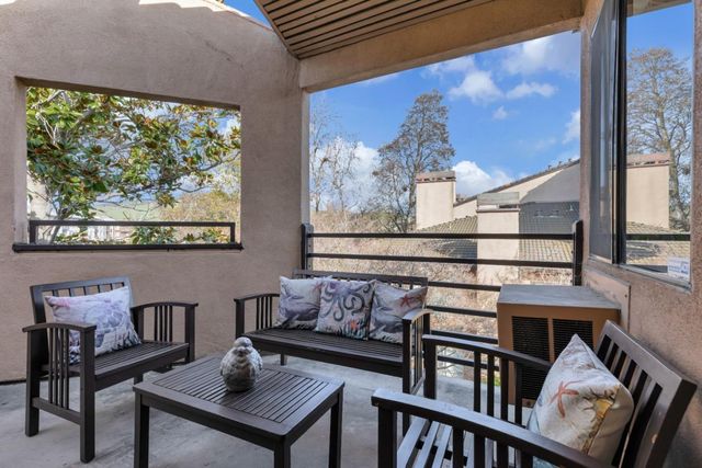 a view of a chairs and table in a balcony