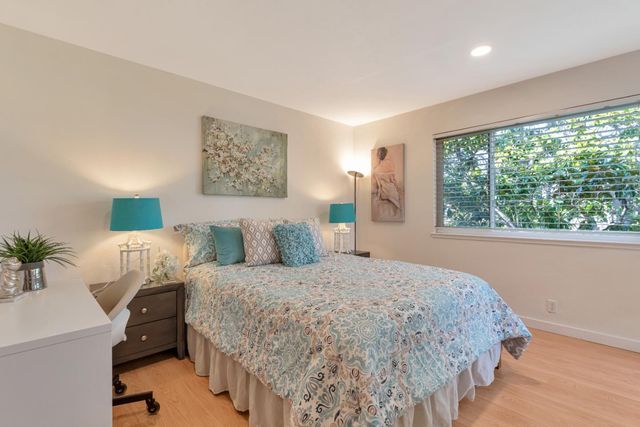 a bedroom with a large bed and a large window