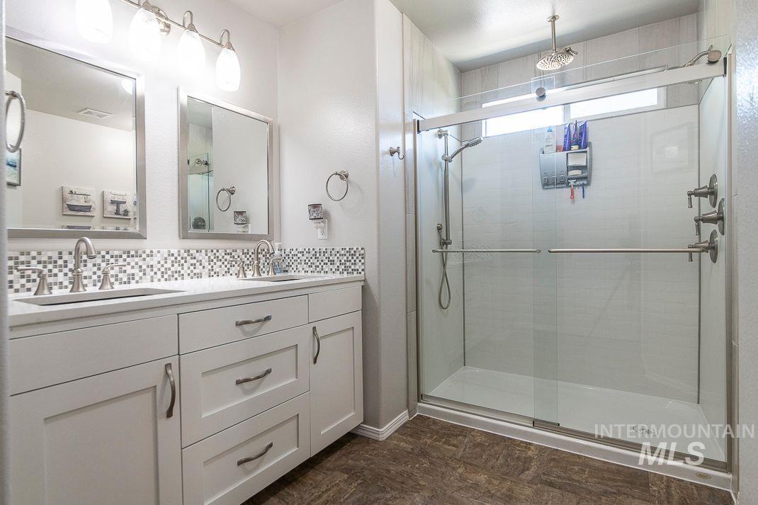 3013 Gala Trail Emmett, ID 83617 - Photo 15 of 22 Full bath featuring a stall shower, backsplash, and double vanity