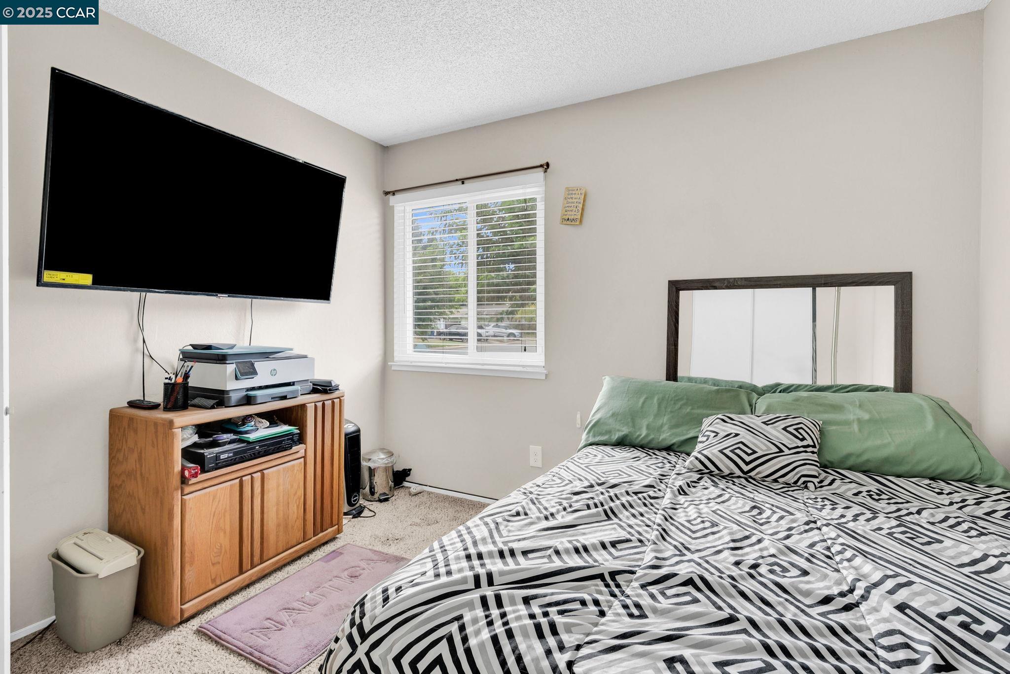 265 Tahoe Drive Rio Vista, CA 94571 - Photo 16 of 24 a bedroom with a bed and flat screen tv