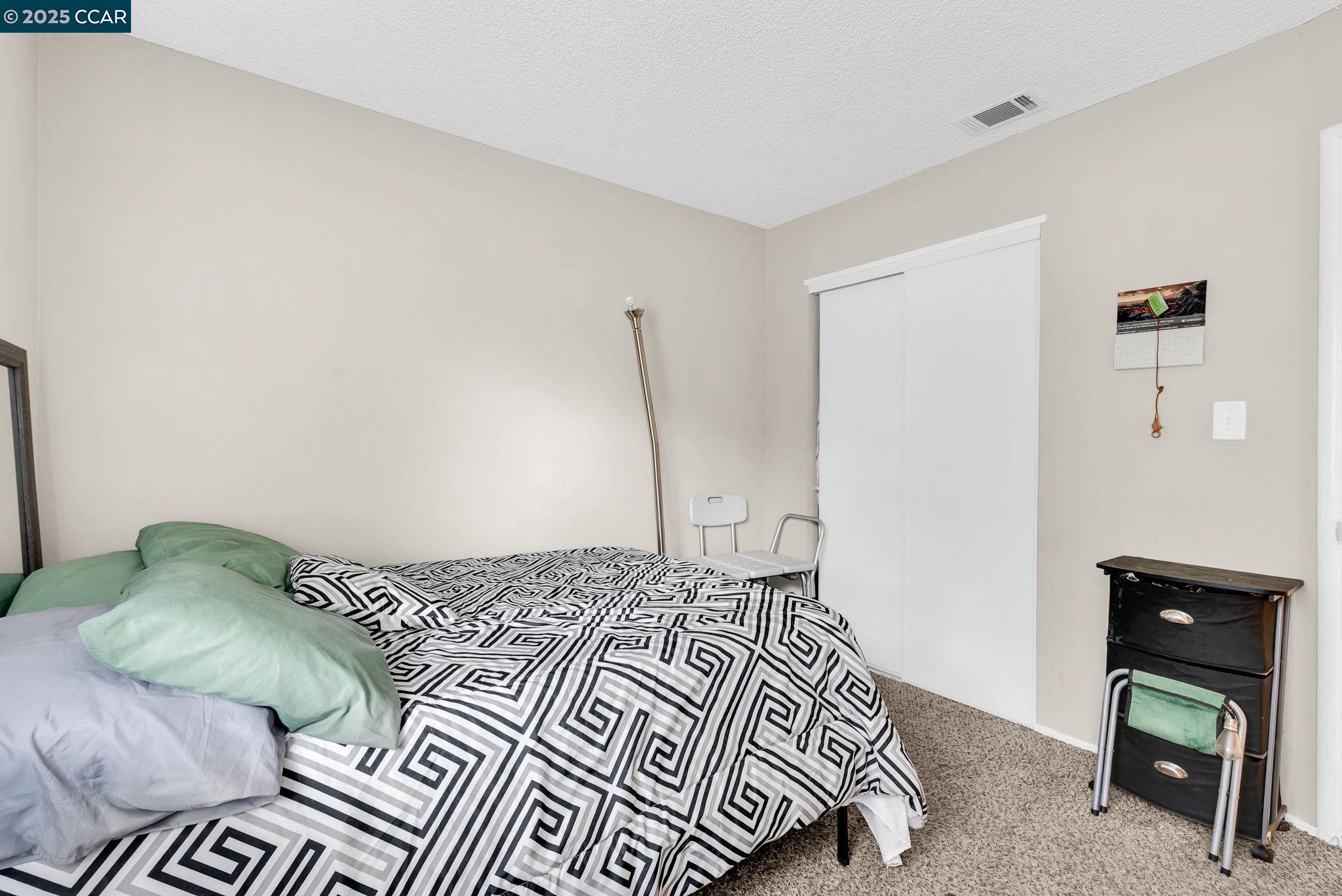 265 Tahoe Drive Rio Vista, CA 94571 - Photo 17 of 24 a bedroom with a bed and a wall painting