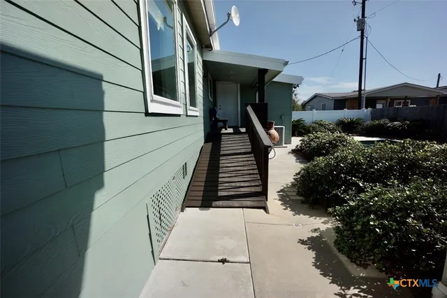 a living room with furniture and a dining table